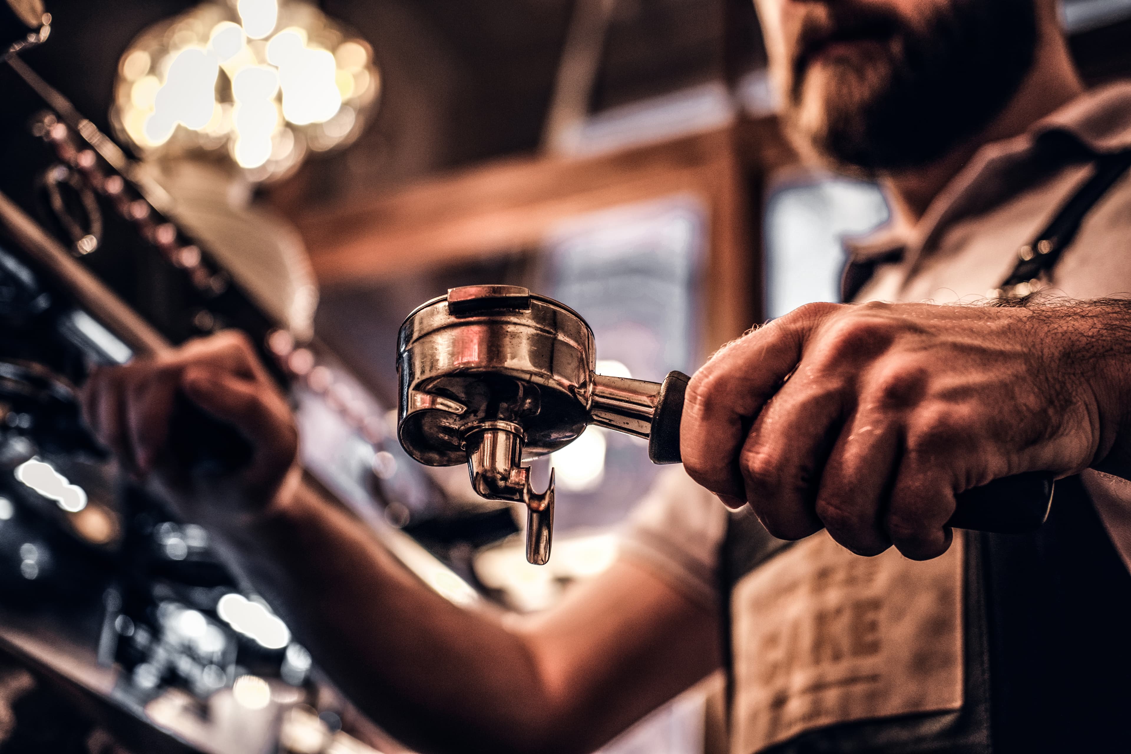 Barista preparing espresso at the bar