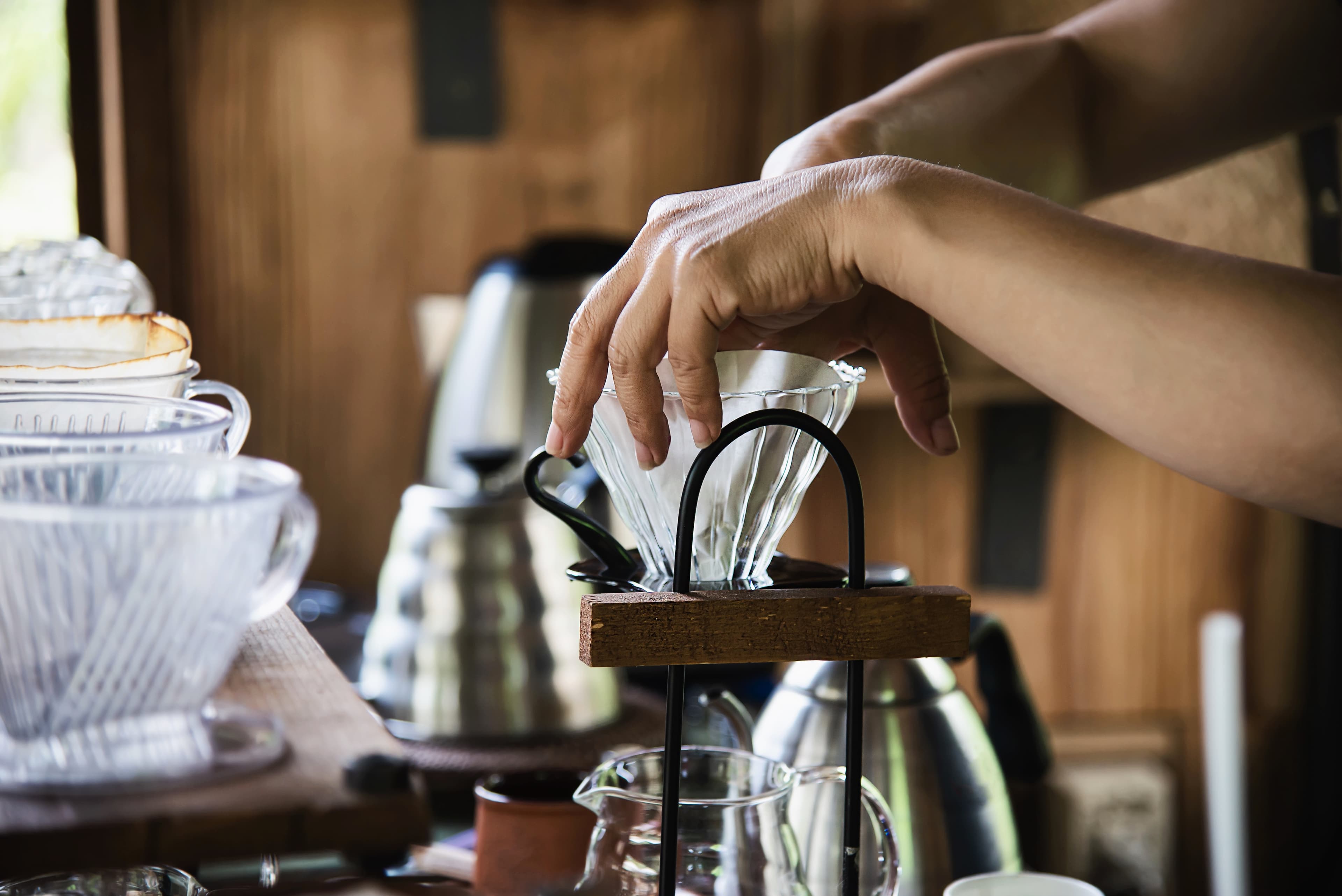 Barista preparing pour-over coffee in a vintage coffee shop